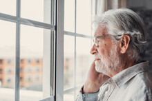 Pensive Elderly Mature Senior Man In Eyeglasses Looking In Distance Out Of Window, Thinking Of Personal Problems. Lost In Thoughts Elderly Middle Aged Grandfather Suffering From Loneliness, Copy Space