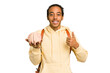 Young African American man holding a brain isolated smiling and raising thumb up