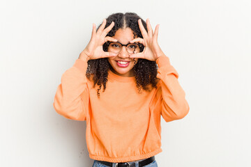 Wall Mural - Young african american woman isolated on white background excited keeping ok gesture on eye.