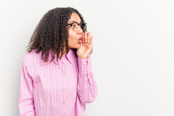 Wall Mural - Young african american woman isolated on white background is saying a secret hot braking news and looking aside