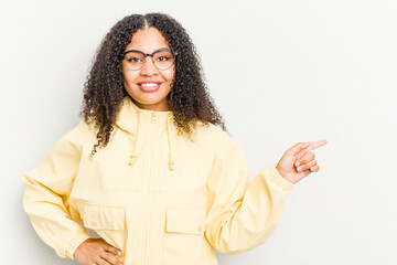 Young african american woman isolated on white background smiling cheerfully pointing with forefinger away.