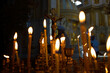 Cross with crucifix in focus, lit wax candles, funeral service, prayers for salvation of soul. Memorial service, an Orthodox church. Concept of Christian religion.
