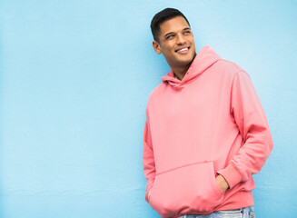 happy, casual and man in studio thinking, relax and normal against a blue background space. laugh, c