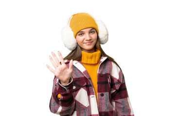 Poster - Teenager caucasian girl wearing winter muffs over isolated background counting five with fingers