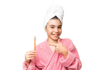 Poster - Little girl brushing teeth over isolated chroma key background and pointing it