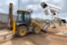 CCTV Camera Watching An Excavator And Workers Working On A Construction Site.
