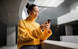 © Nicholas F/peopleimages.com - Woman, phone and texting in office building, thinking and calm while on internet, search and reading. Asian, girl and business entrepreneur with smartphone for research, office space or idea in Japan