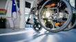 Close-up of wheelchair with senior woman at hospital corridor.