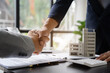 © NINENII - Close up shake hands, Considering buying a home, investing in real estate. Broker signs a sales agreement. agent, lease agreement, successful deal.
