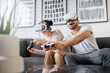 © Nicholas F/peopleimages.com - Virtual reality, gaming and metaverse with a couple playing video games in their home together for fun or enjoyment. VR, game and 3d ai with a man and woman gamer bonding in a house living room