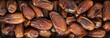 The surface texture of dried dates. Natural oriental sweets. Panoramic background with natural oriental sweets.