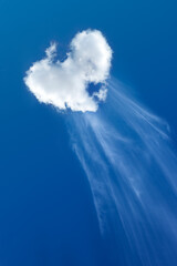 Heart shaped cloud isolated on blue sky background.