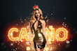© Aliaksandr Marko - Beautiful girl in a gold dress posing against the background of casino paraphernalia, cards, dice, chips. Concept banner poster for the casino, gambling, a hat for the site.