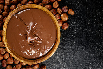 Poster - Hazelnut butter in a plate with peeled hazelnuts. 