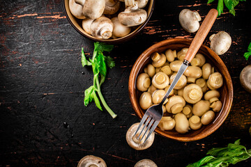 Sticker - Homemade pickled mushrooms in a wooden bowl. 