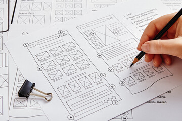 web design project concept. close up photo of a ux designer working on website project with a large 