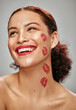 © K. A./peopleimages.com - Makeup, red lipstick and kiss on face of woman model in studio for cosmetics, love and happiness. Beauty headshot of person happy for valentines day spa facial skin idea or skincare motivation