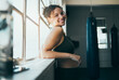 © K. A./peopleimages.com - Portrait, window and woman with smile, fitness and workout for wellness, healthy lifestyle or exercise. Happy female, lady or athlete in gym training, sunshine or practice for cardio, energy or power
