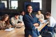 © Prostock-studio - Modern entrepreneur concept. African american businesswoman standing with folded arms in conference room during meeting