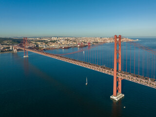 Poster - The 25 April bridge (Ponte 25 de Abril) located in Lisbon, Portugal, crossing the Targus river. Drone.