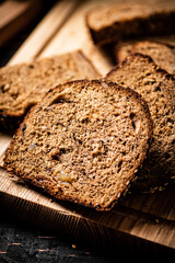 Poster - Slices of fresh bread on a wooden cutting board. 