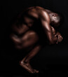 © Michael C/peopleimages.com - Nude, art and naked body of a strong black man in dark studio for sexy muscle and sexuality. Sport person or bodybuilder model for motivation, health and wellness in art deco form or shape background