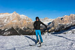  A young man, a happy skier, admires the Italian Dolomites mountains. Skiing, winter sports.  Młody mężczyzna, szczęśliwy narciarz podziwia włoskie góry Dolomity. Narty, sporty zimowe.