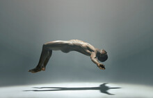 Float, Man And Naked Model In A White Background Studio For Creative Art With Shadow. Isolated, Floating And Nude Body Of A African Male In The Air With Light Showing Artistic And Erotic Projection