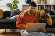 © cherryandbees - Young couple is looking at the laptop at home
