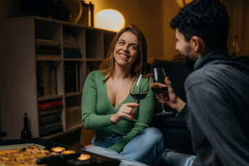 Canvas Print - Young couple drinks red wine at home, Valentine's day