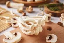 Wooden Board With Fresh Mushrooms On Table, Closeup