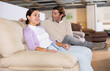© JackF - Man and woman sitting on sofa in furniture store