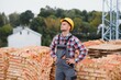 © Serhii - Construction worker man in work clothes and a construction helmet. Portrait of positive male builder in hardhat working at construction site.