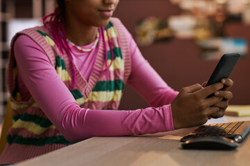 Wall Mural - Close up black teenage girl using smartphone at home texting friends