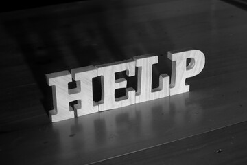 Help, text words typography written with wooden letter on black background, life and business motivation inspirational