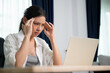 © Monster Ztudio - Office syndrome. Overworked tired young asian woman feeling headache, having eyesight problem after computer laptop work. Stressed young woman suffering from fatigue at home