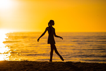 Wall Mural - Happy teen girl enjoy tropical beach vacation at sunset