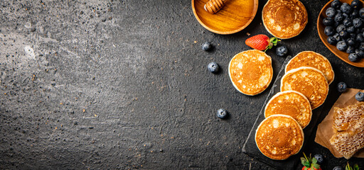 Wall Mural - Pancakes on a stone board with fresh berries. 