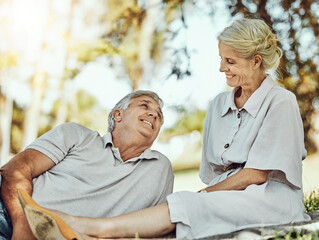 Canvas Print - Retirement, love and picnic with a mature couple outdoor in nature to relax on a green field of grass together. Happy, smile and date with a senior man and woman bonding outside for romance