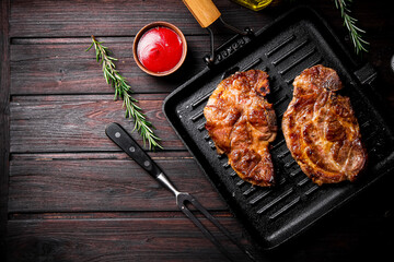 Sticker - Grilled pork steak in a frying pan. 