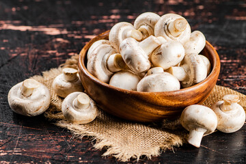 Poster - Mushrooms in a wooden plate on a napkin. 