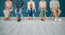 Legs, Hiring And People In A Waiting Room For Job Interview In Office. Human Resources, Hr Or Group Of Employees, Business Men And Women Sitting In A Row And Wait For Recruitment In Company Workplace