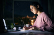 © Jordan C/peopleimages.com - Girl, reading and studying on laptop at night for research, education and internet project. Serious young student, writing notes and learning on computer at dark desk for homework, planning and tech