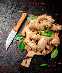 Poster - Ginger on a cutting board with a knife. 