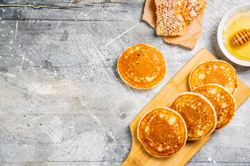 Wall Mural - Pancakes on a cutting board with honey. 