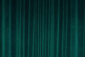 vertical fold on green velvet curtains for background and design. soft focus