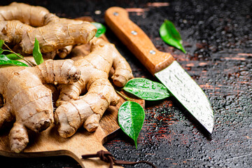 Poster - Ginger on a cutting board with a knife. 