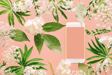 Smartphone Mockup Among Assorted Floral And Jungle Tree Green Leaves And White Flowers On Peach Pink. Natural Friendly Plants Care Or Gardening Planting Mobile App Technology