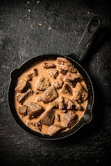 Sticker - Liver cooked in a frying pan. 