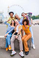 Multiracial young people together meeting and social gathering - Group of friends with mixed races having fun outdoors in the city- Friendship and lifestyle concepts